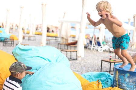 children-having-fun-on-the-beach-jumping-on-big