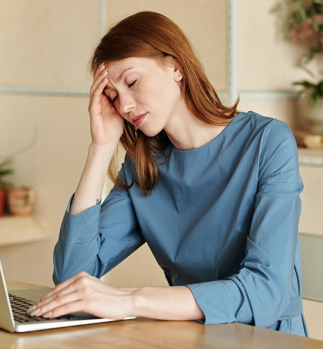 headache. Migraine headache. Woman suffering from headache during working.