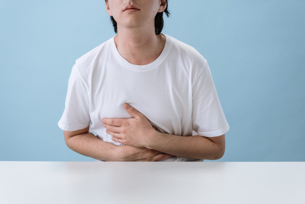 Man in White Shirt Suffering from a Stomach Pain. Constipation