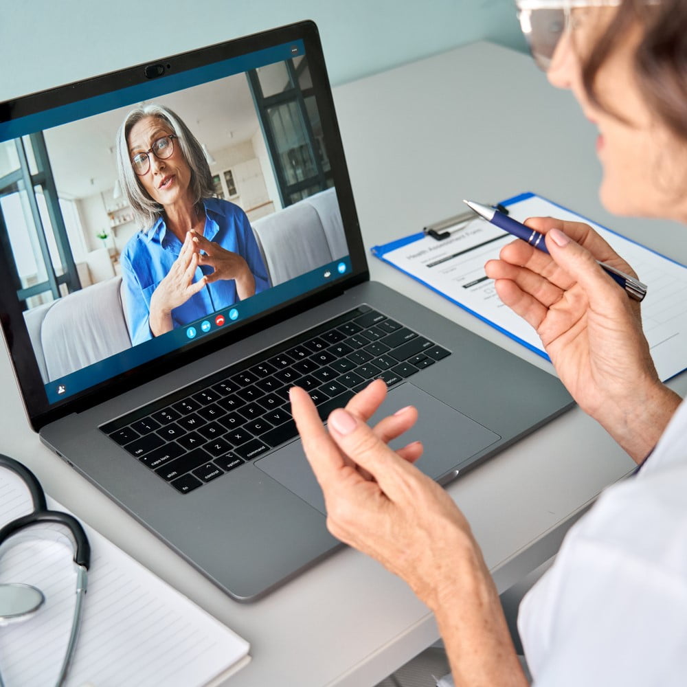 Female doctor therapist consulting older senior patient via virtual video call visit using laptop computer. Digital online healthcare, distance telemedicine. Telehealth videocall. Teleconsultation.