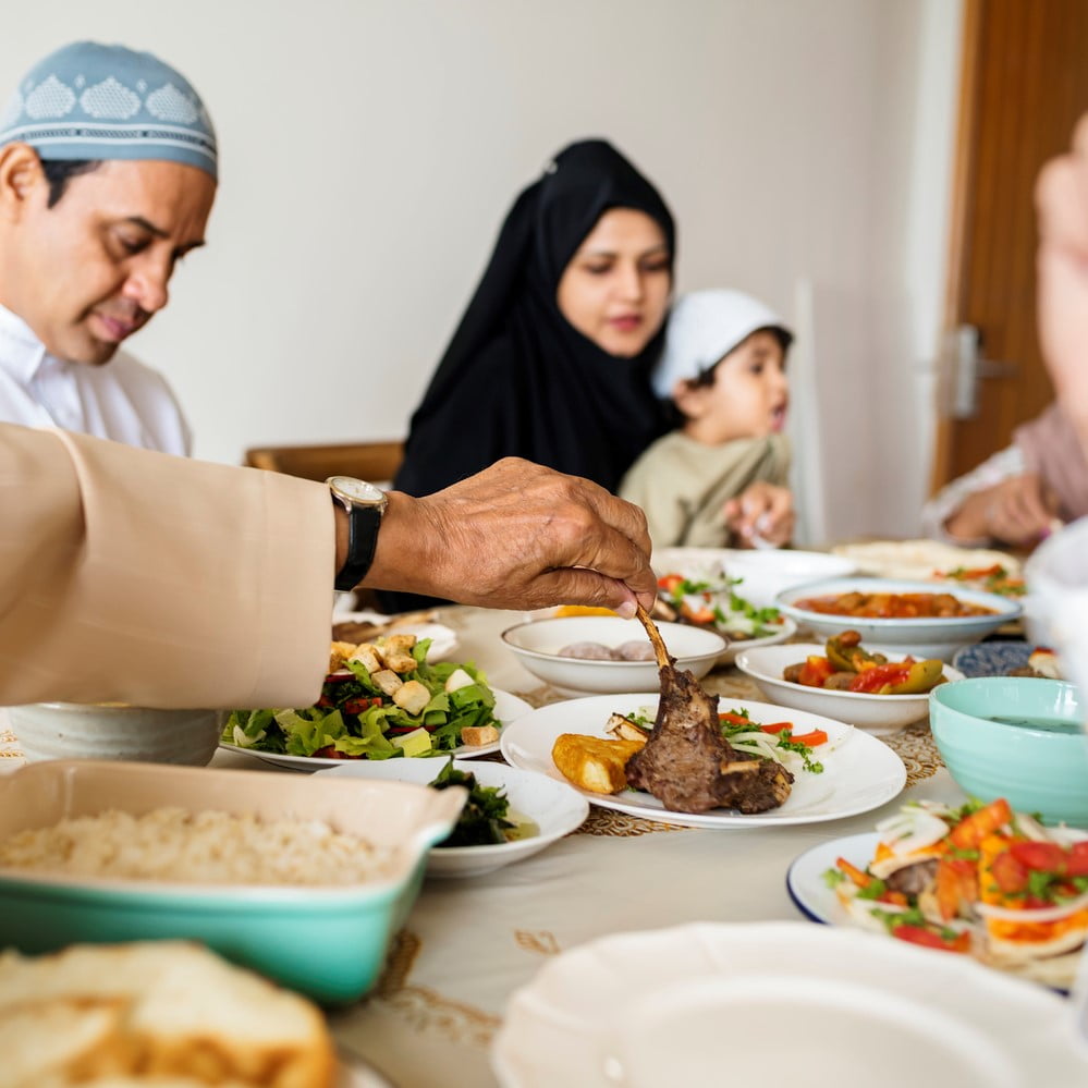 Muslim family having Eid Al Adha feast. Digestive health during Eid Al Adha.