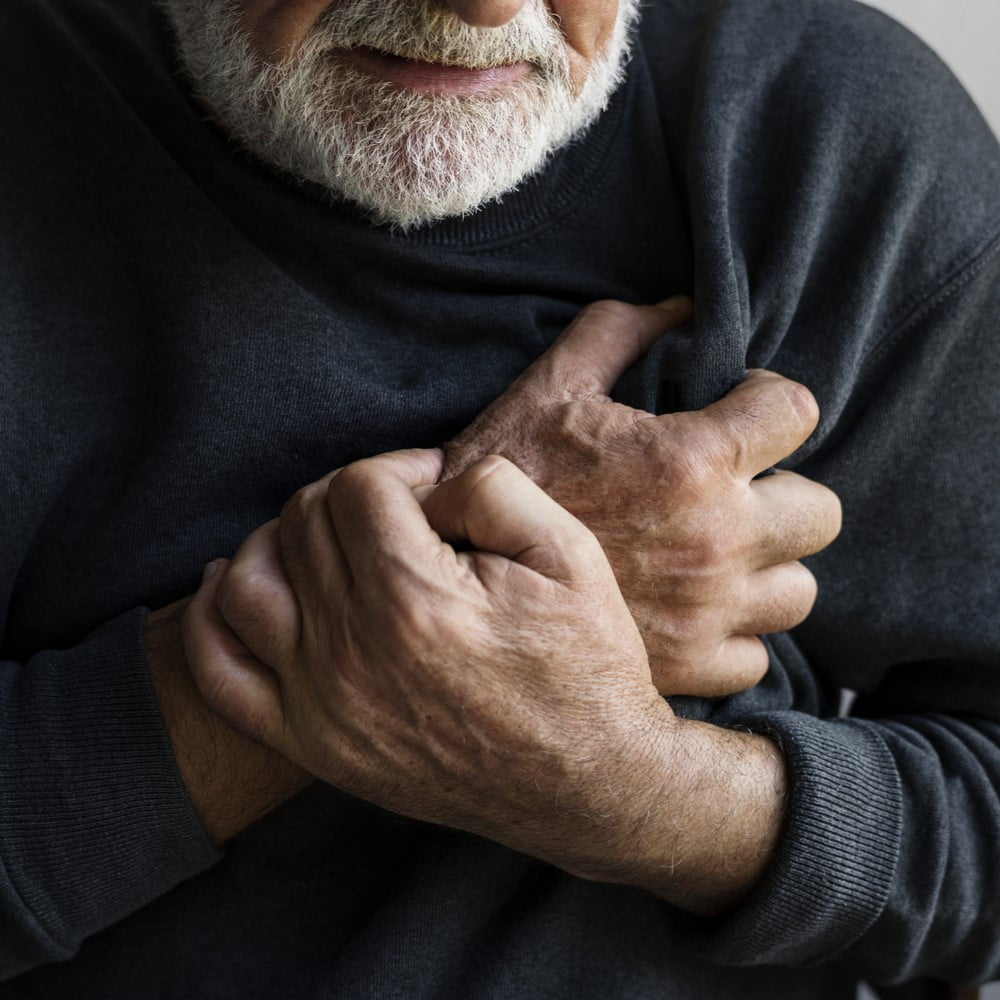 Close up of elderly man having a heart attack. risk factors for heart attacks concept.