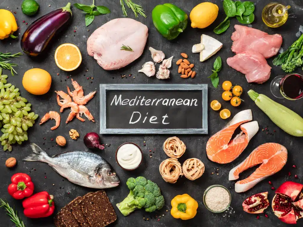 Mediterranean diet concept. Top view of food ingredients and chalkboard with words Mediterranean Diet in center. Dark background. Memory booster food