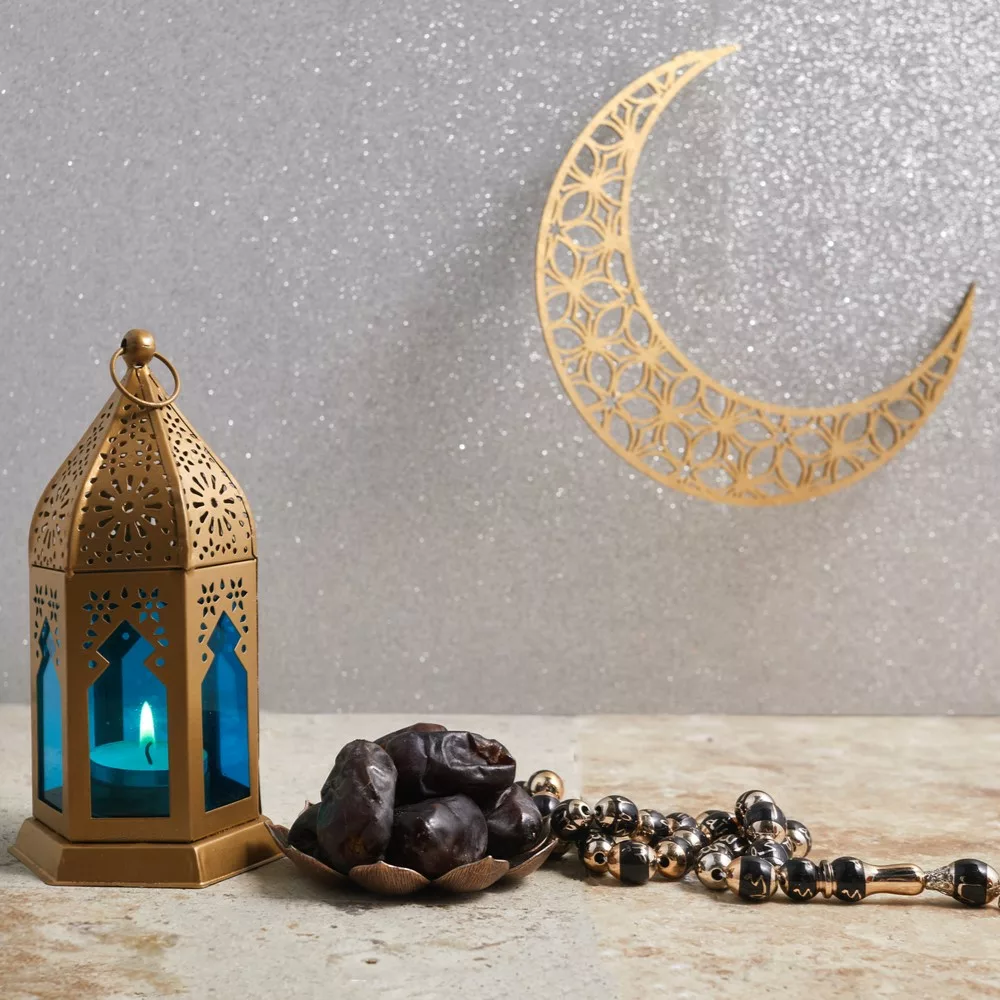 Muslim Holy Month Ramadan Kareem - Ornamental Arabic Lantern with Burning Candle. Tips for Fasting concept.